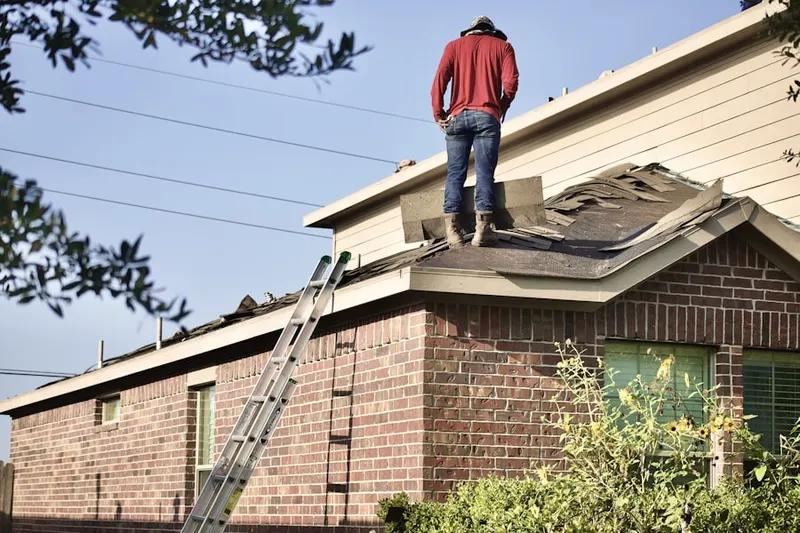 Professional roofer working on a residential roof in Douglass